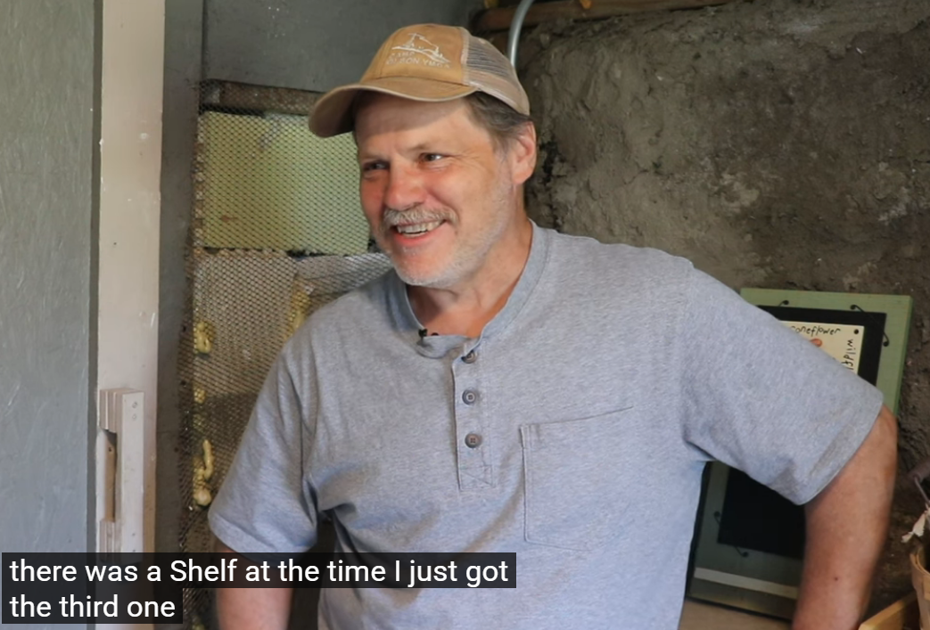 A farmer stands in a building where he installed HUG Hydronics in floor he ating