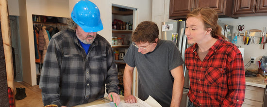 Steph and Randy are going over plans with their contractor