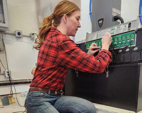 Steph is connecting a thermostat to control board on a HUG Hydronics in-floor heating system