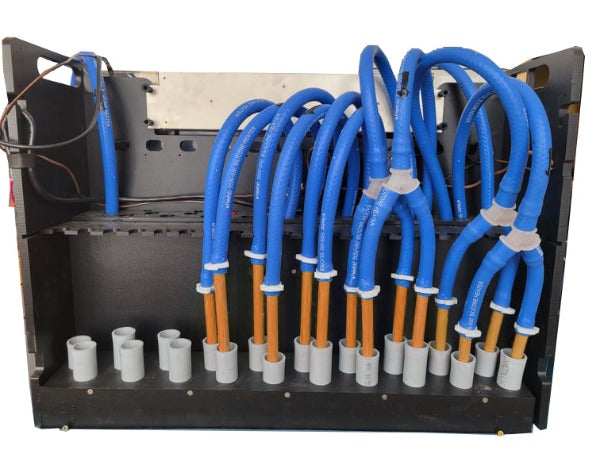 The HUG Hydronics in floor heating system back view has the blue hoses connected to the orange pex pipes and clamped with a white clamp