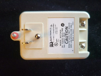 bottom view of smart thermostat power supply. Plugs in to a regular outlet with wire connecting screws on bottom